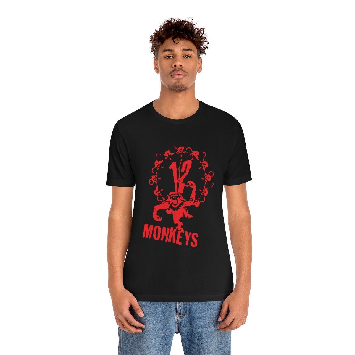 Young man wearing a very comfortable black 12 monkeys shirt with red graphics to wear at your favorite convention